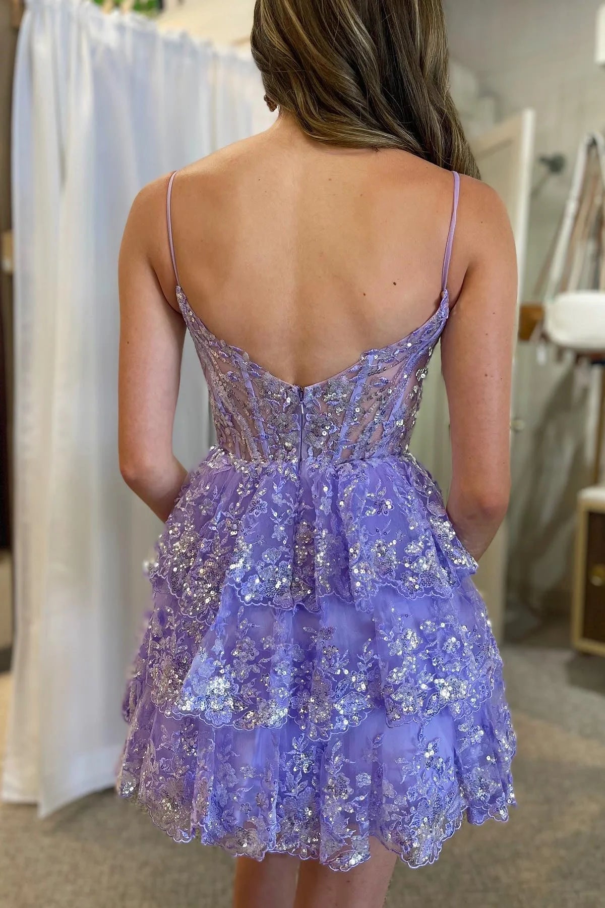 Model wearing a lavender sequined tulle homecoming dress.
