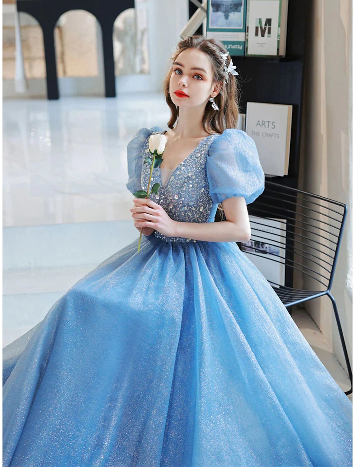 Close-up of the floral pattern, glitter, beading, and sequin details on the ball gown.