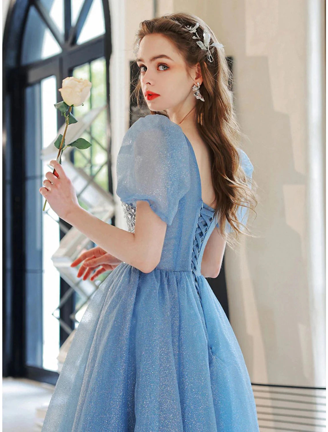 Back view of the elegant A-line evening gown, showcasing its flowing tulle skirt.