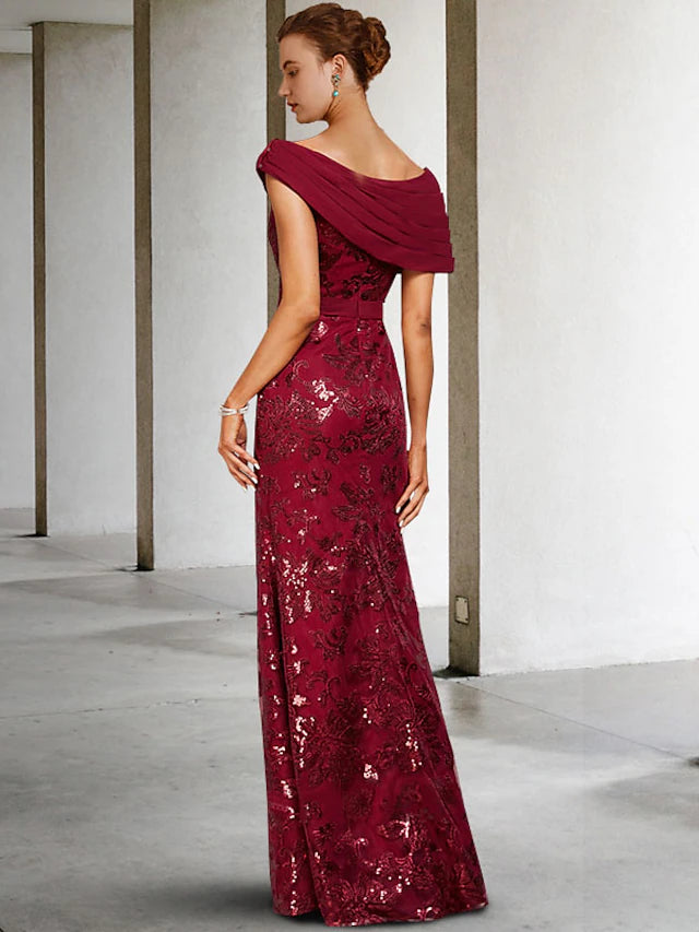 Close-up of the ruched bodice and sparkling sequin appliques on the dress.