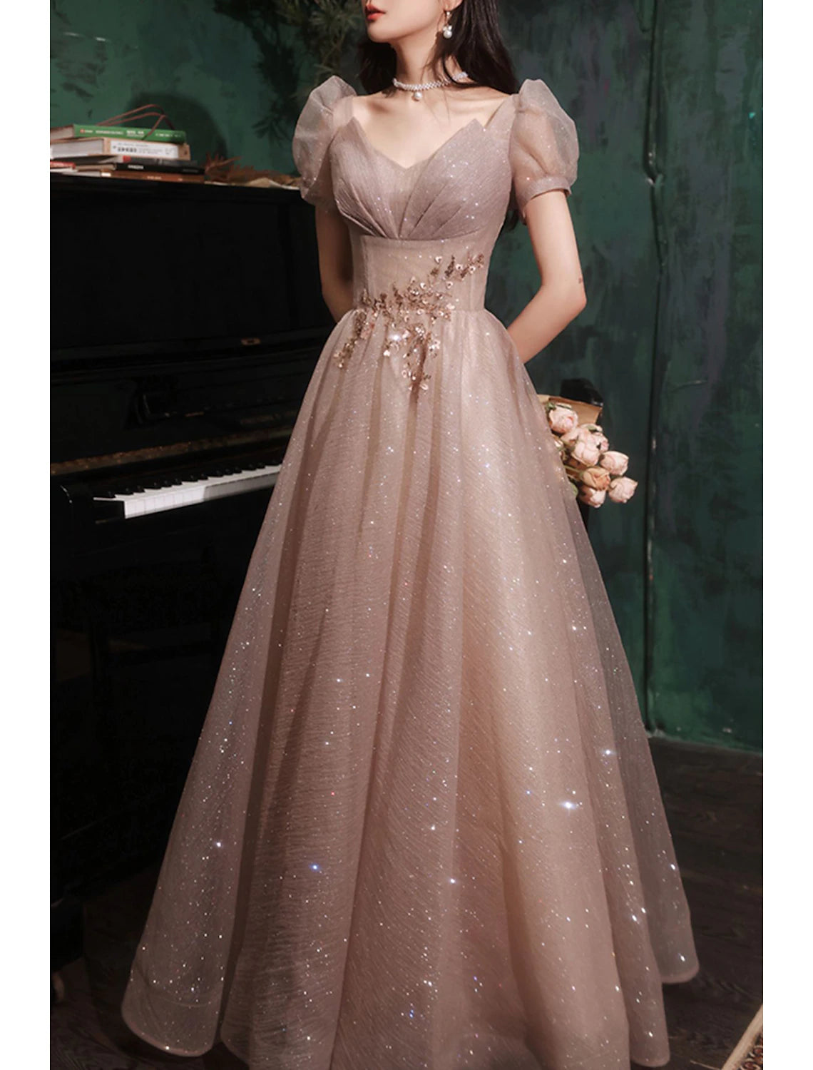 Back view of a model in a floor-length sequin tulle prom dress.