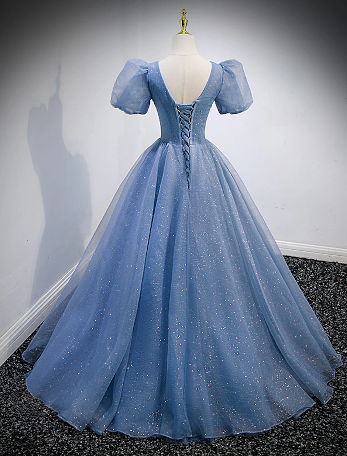 Close-up of the sequin and tulle fabric on the A-line quinceanera dress.