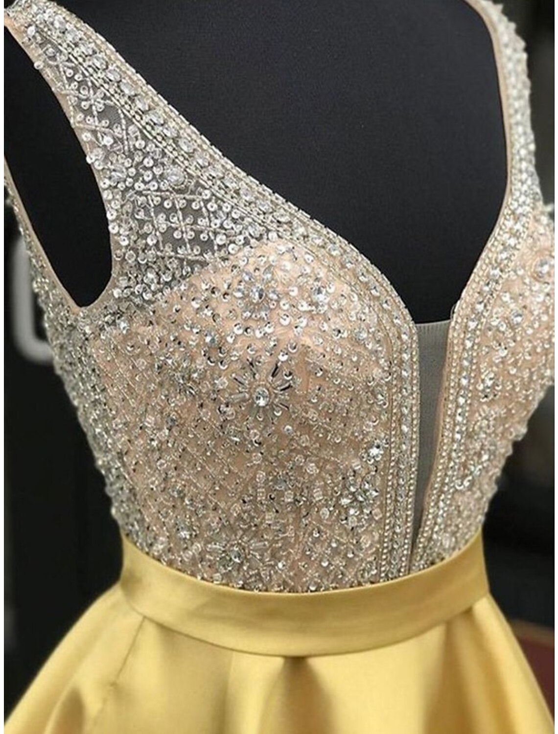 Close-up of the beaded detail on the satin A-line homecoming dress.