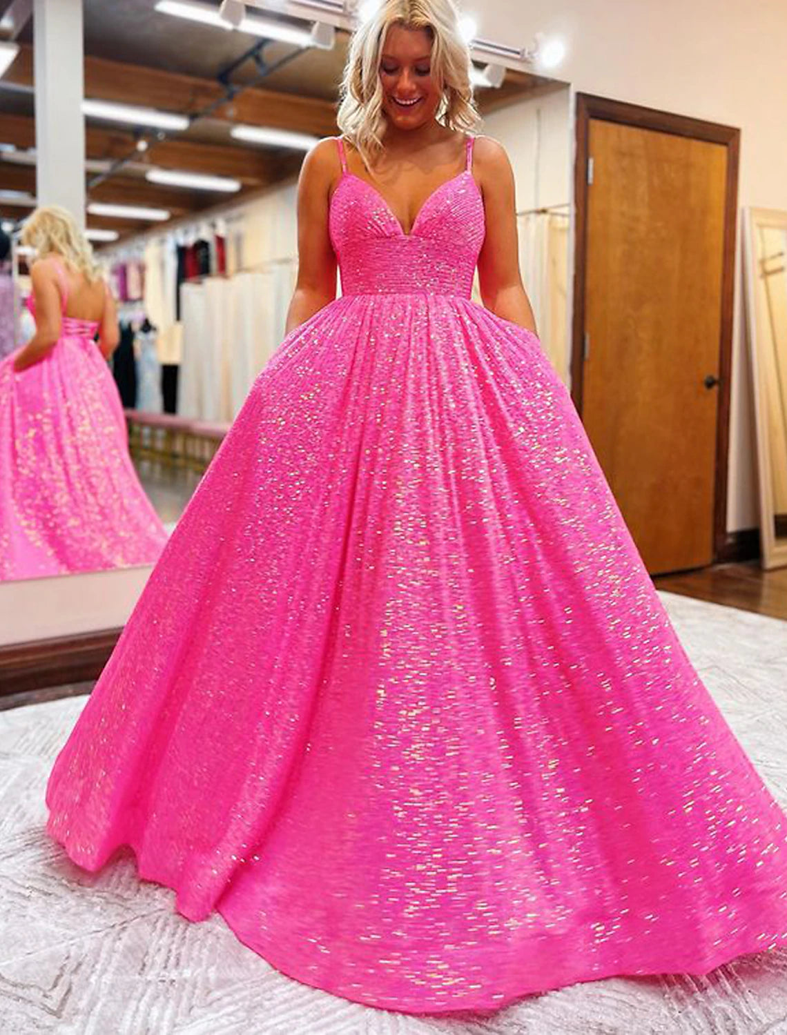 Front view of a sparkling A-line sequined prom dress with a V-neckline and sweep train.