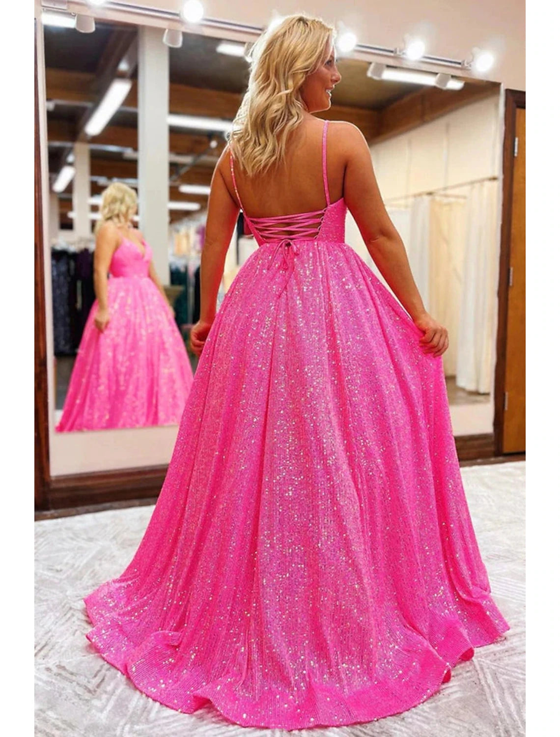 Back view of the sequined A-line prom dress, featuring a backless design and pleats.