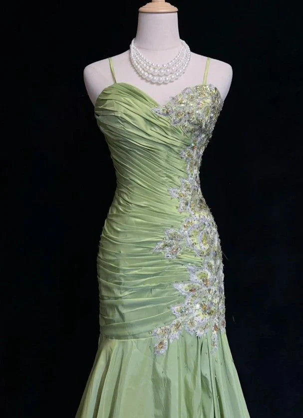 Side view of an elegant sparkling A-line prom dress with flowing skirt.