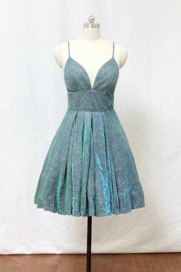 Sparkling silver-green A-line homecoming dress with spaghetti straps and pockets.
