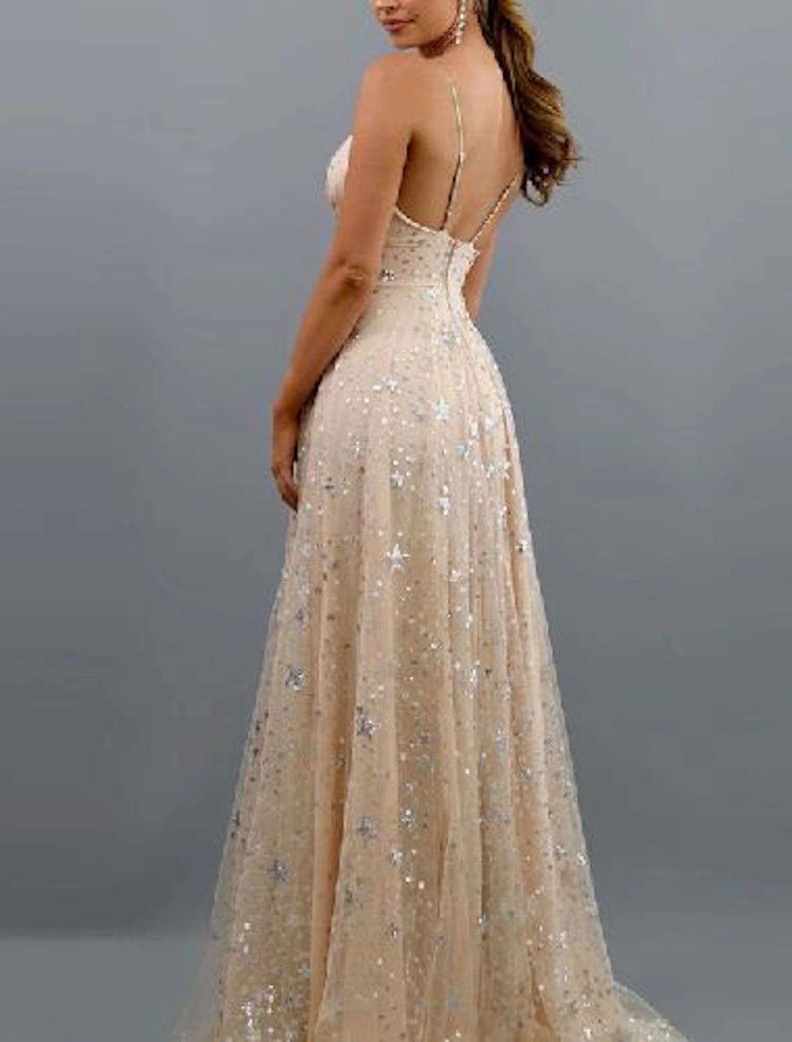Model wearing the sparkling A-line V-neck dress, showcasing its elegant drape.