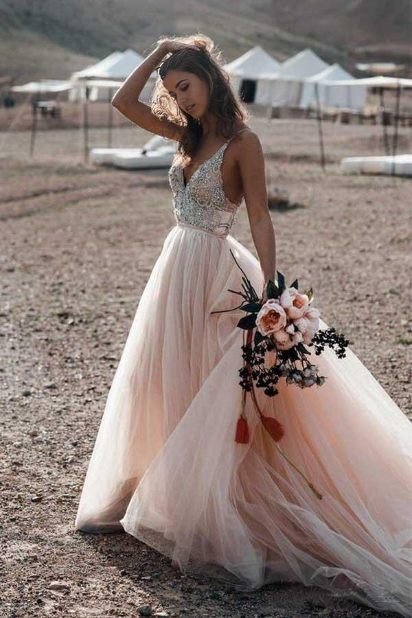 Back view of the wedding dress, showcasing its elegant backless design and beading.