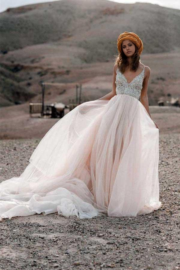 Close-up of the V-neckline and delicate sparkle beading on the bridal gown.