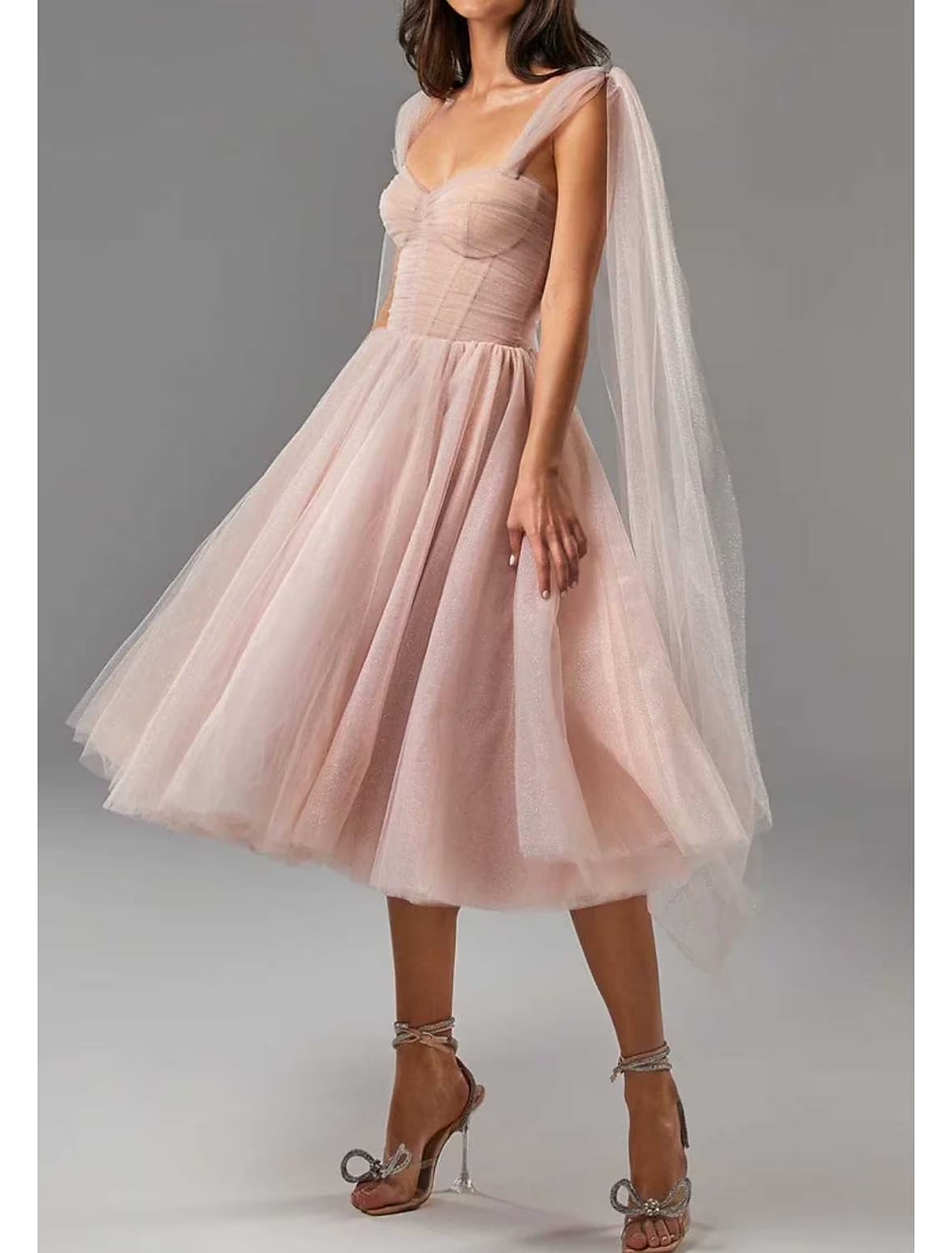 Back view of a square neck tea-length ball gown dress with glitter details.