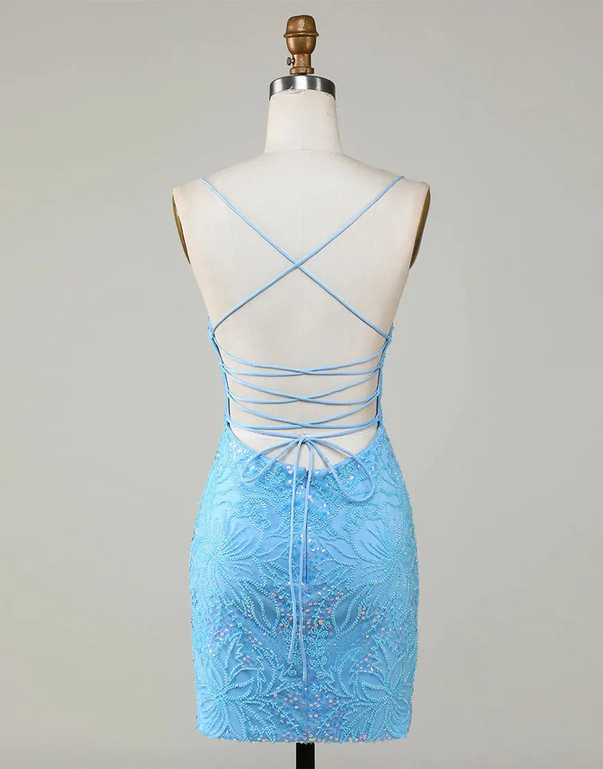 Model showcasing the lace-up back of a blue beaded homecoming dress.