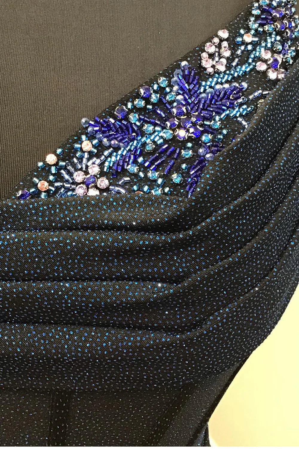 Close-up of the sparkling beading and sweetheart neckline on the dress.