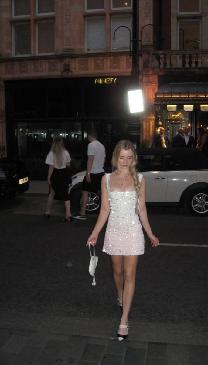 Model wearing the sleeveless ombre white to pink mini dress.