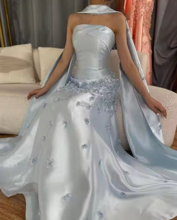 Side profile of the strapless formal gown with sparkling pearls.