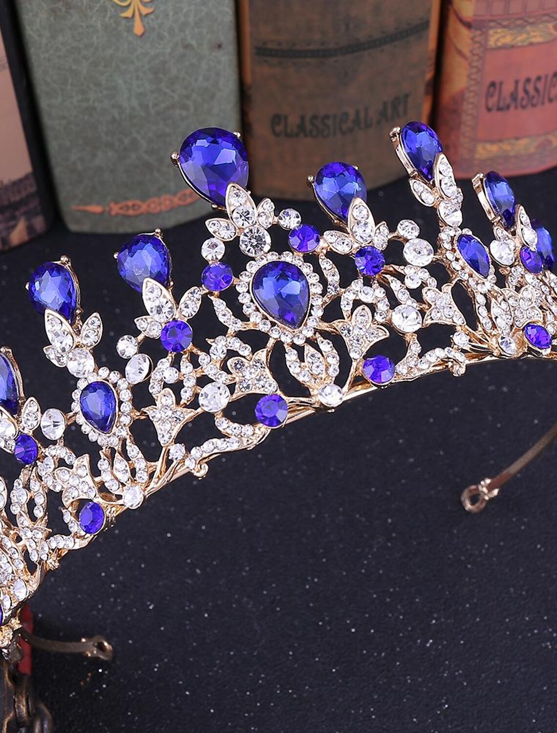 Close-up of crystal and rhinestone details on a queen tiara.
