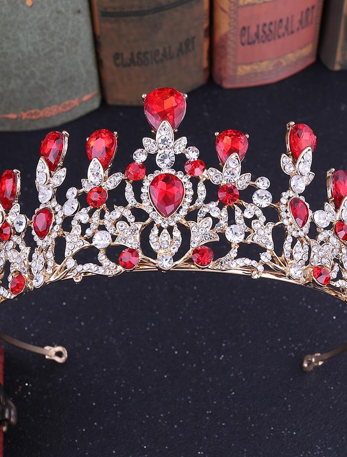 Model showcasing a large crystal queen tiara.