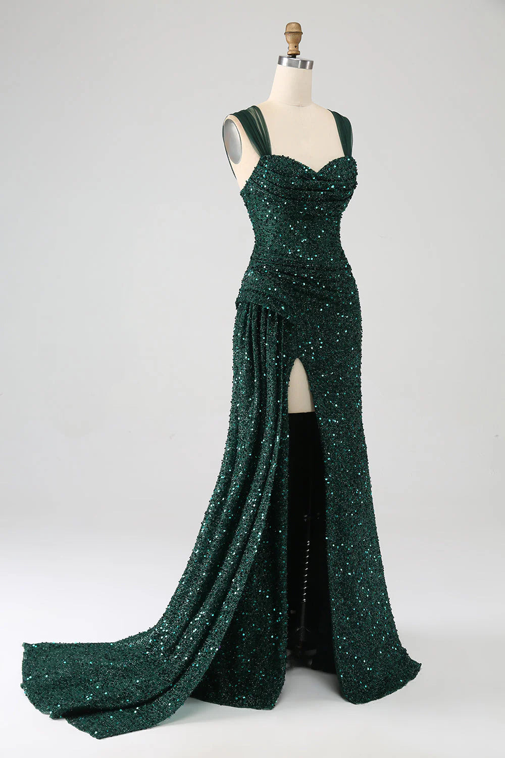 Close-up of the shimmering dark green sequin fabric on the sheath prom dress.
