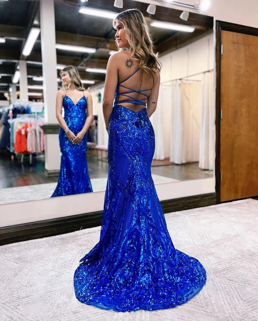Woman posing in an elegant V-neck mermaid sequin long formal gown, side view.