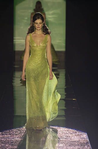 Model wearing a sparkling glitter A-line V-neck prom dress with spaghetti straps.
