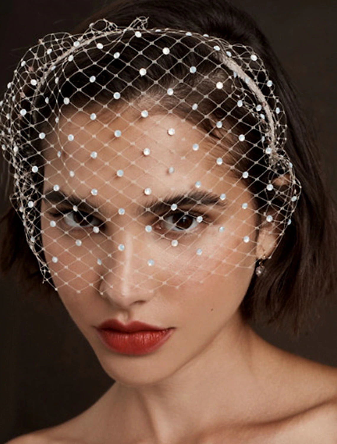 Close-up of a shimmering wedding veil with rhinestone embellishments and glitter tulle fabric.