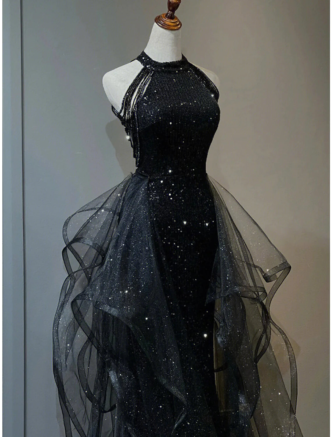 Full length view of a sleeveless sequined dress for formal occasions.