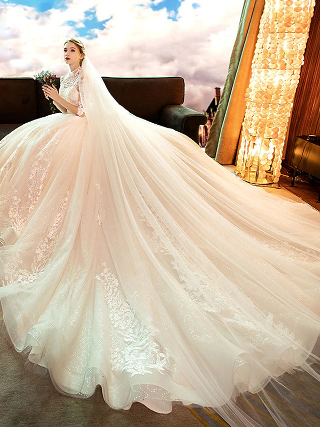 Back view of white high-neck long-sleeve lace ball gown wedding dress with cathedral train.