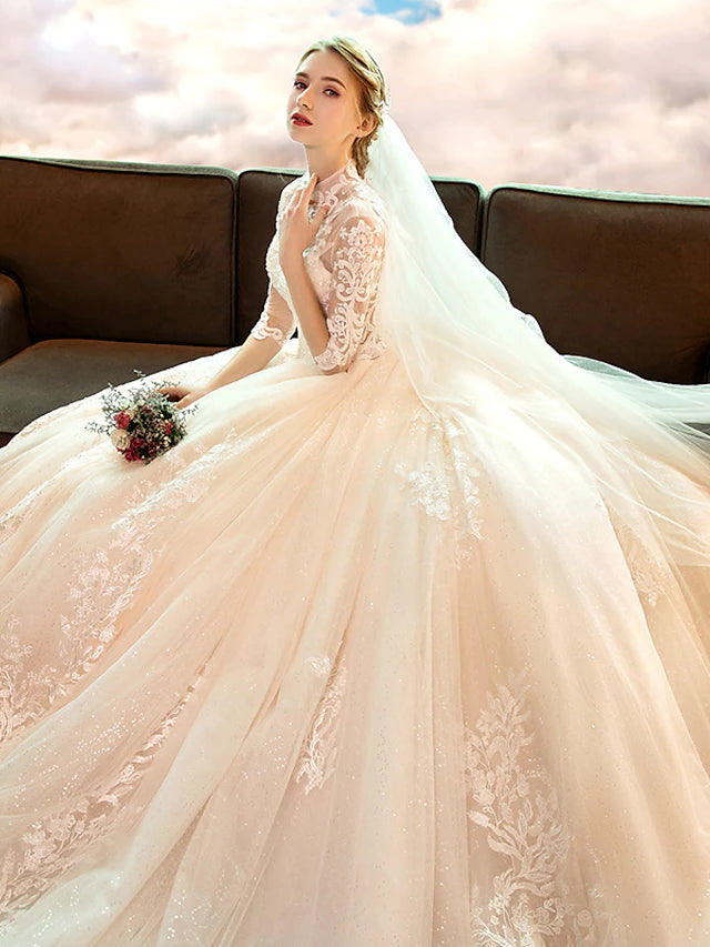 Side view of white high-neck long-sleeve lace ball gown wedding dress with sequin appliques.