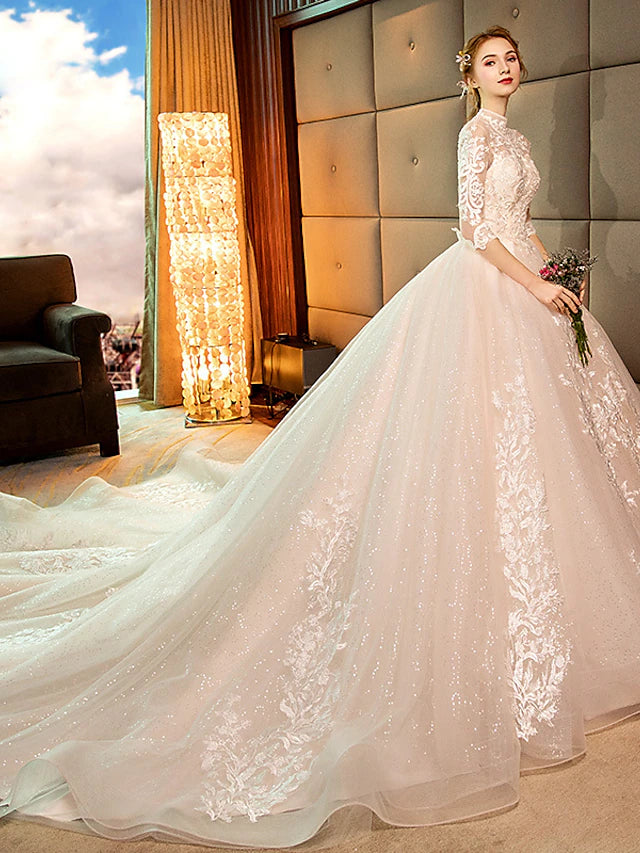 Detail of the long sleeve with lace and sequin embellishments on the wedding dress.