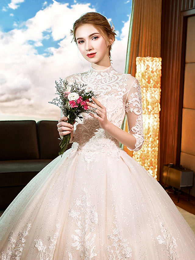 Close-up of the high neckline and intricate lace pattern on the wedding dress.