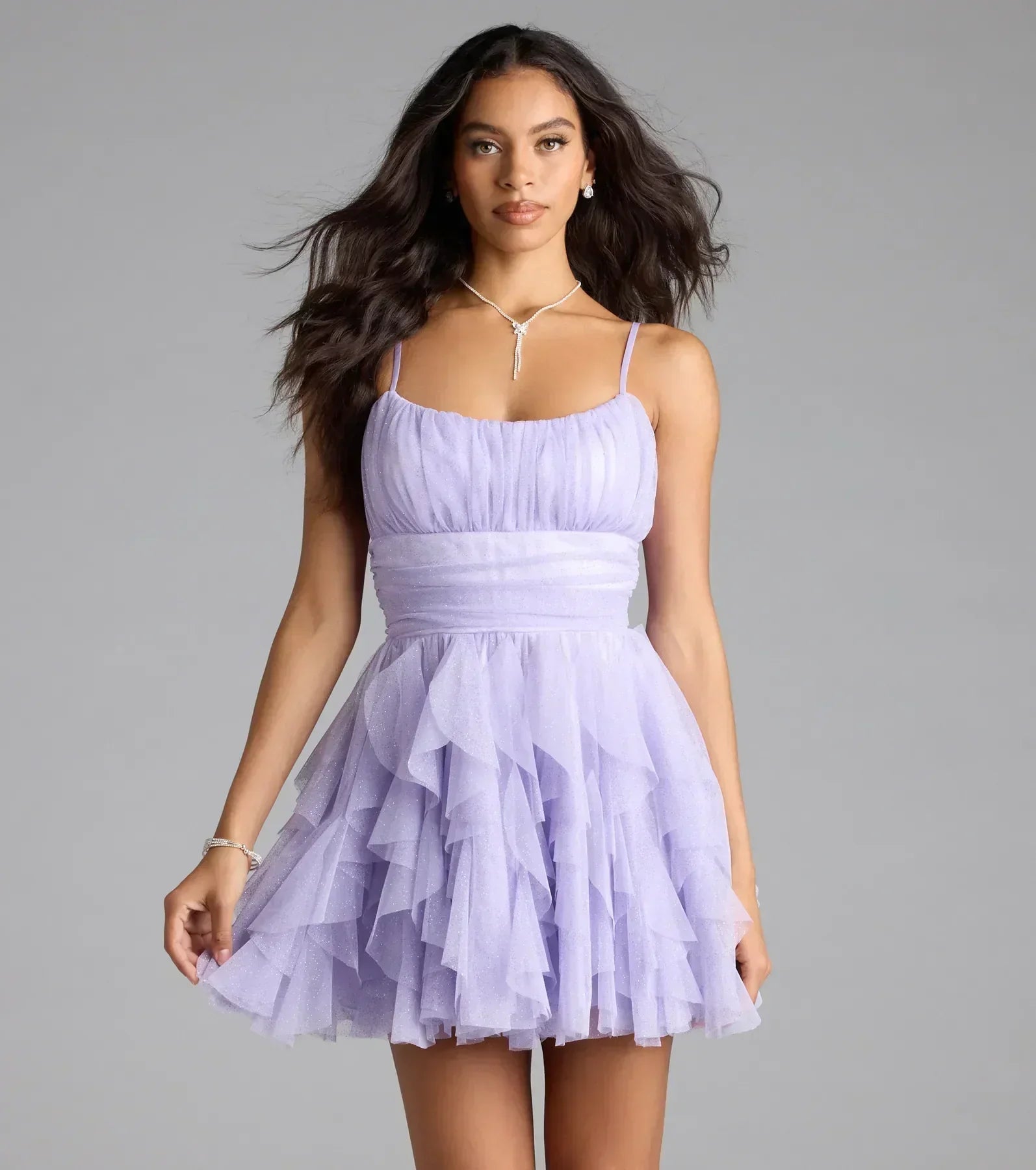 Lavender glitter tulle mini homecoming dress with spaghetti straps and tiered ruffles.