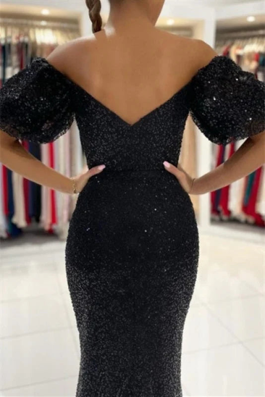 Close-up of the glitter fabric on a long sleeve evening dress.
