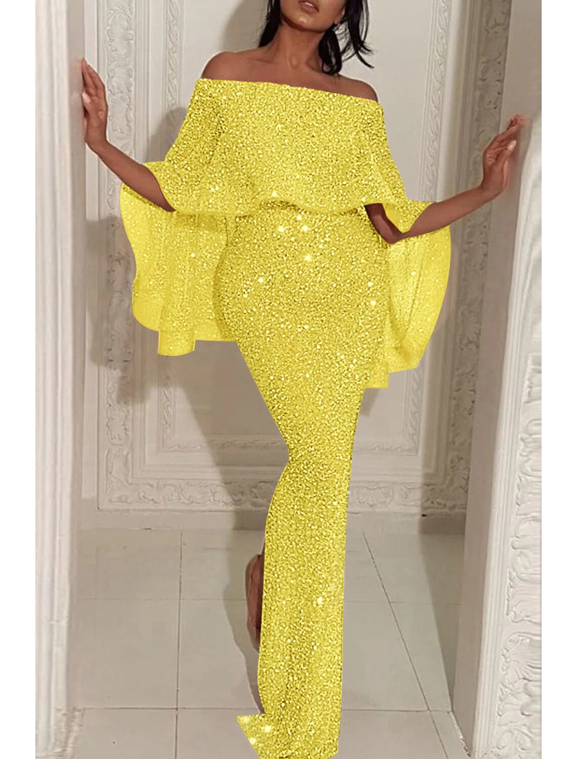 Back view of a sequined mermaid gown, showcasing the sweep train.
