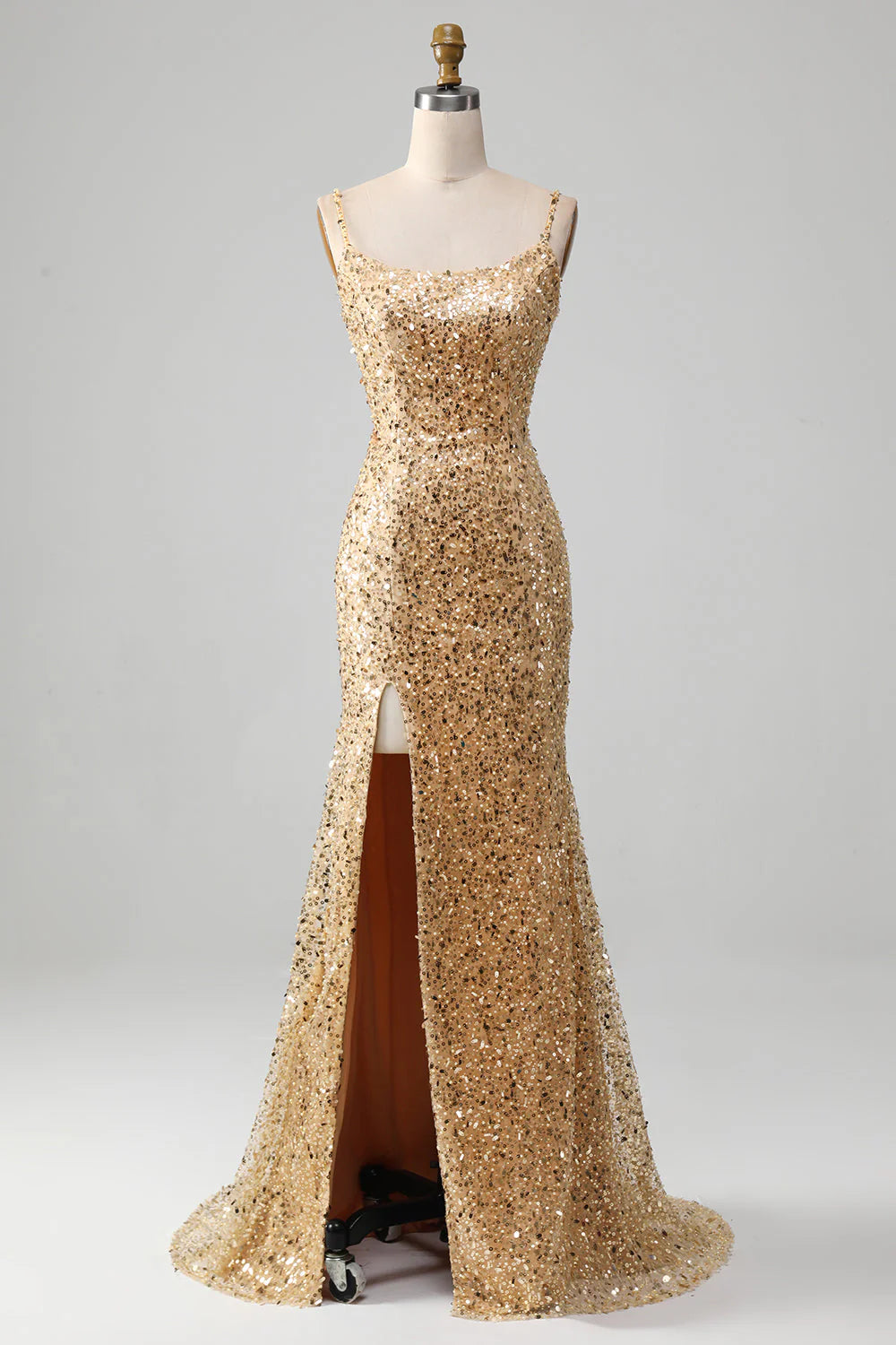 Front view of a golden sequined mermaid prom dress with a side slit.