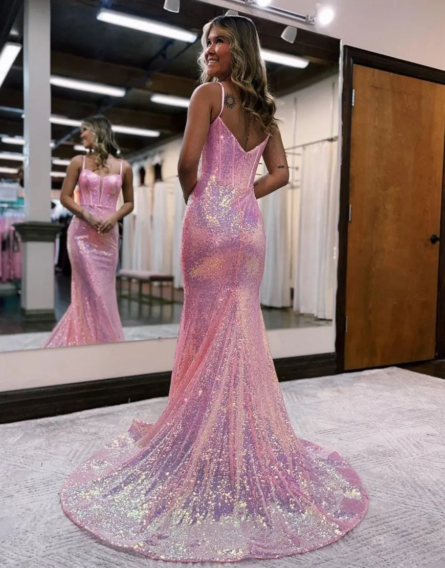 Woman posing in a long glitter mermaid gown, showcasing the back detail.