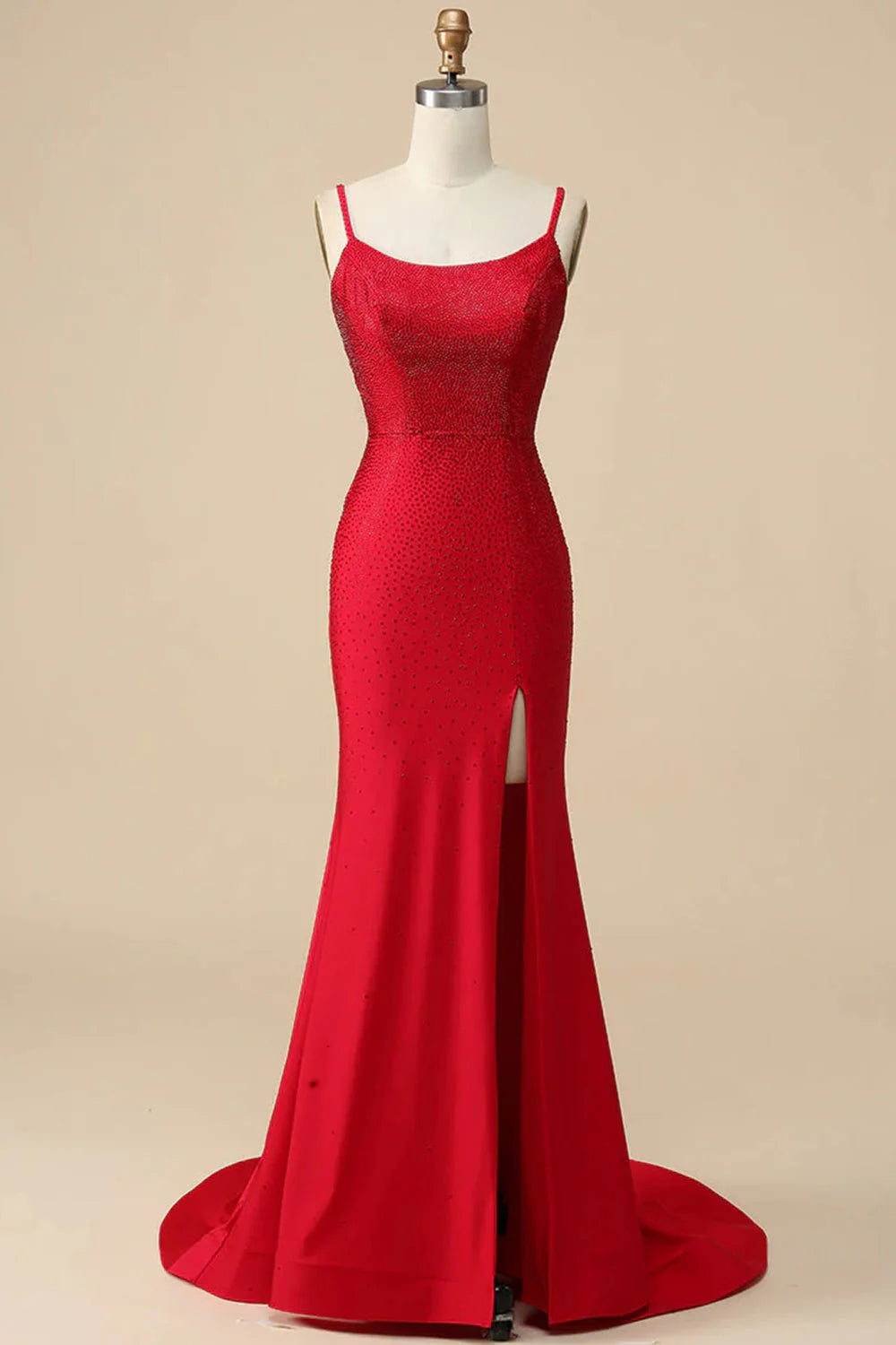 Red sequin mermaid dress with spaghetti straps and a front slit.