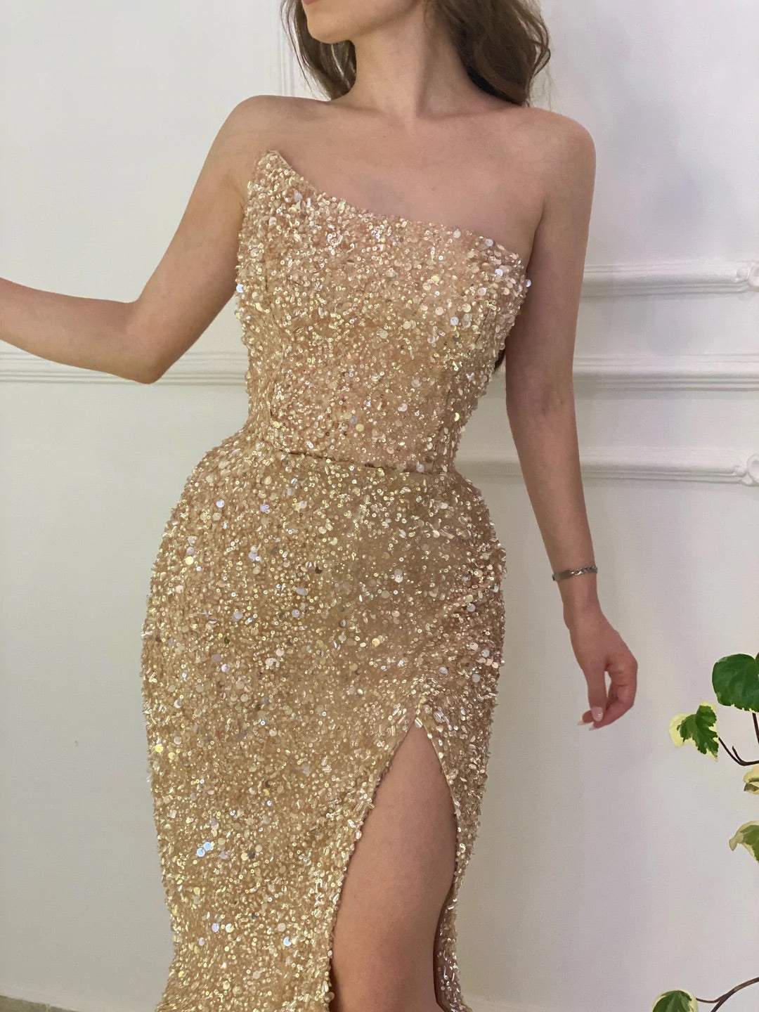Elegant gold sequin strapless formal gown.
