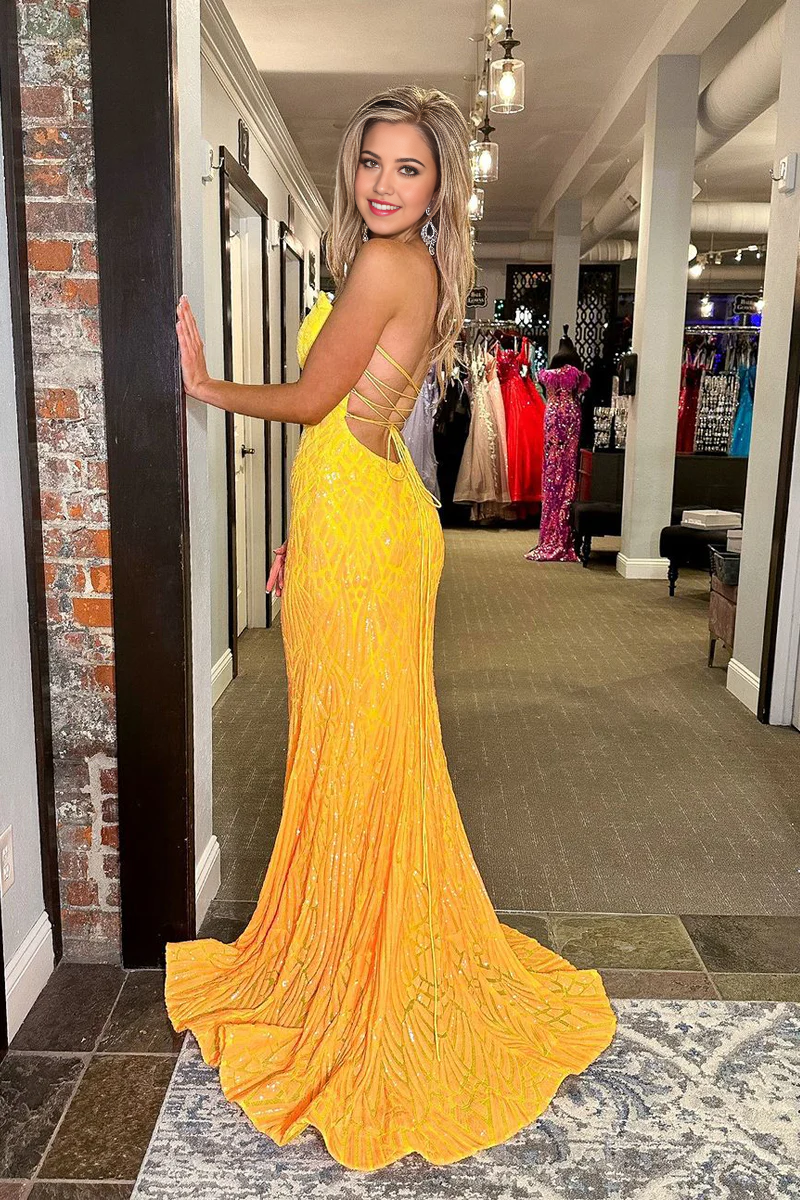 Back view of yellow sequin mermaid prom dress.