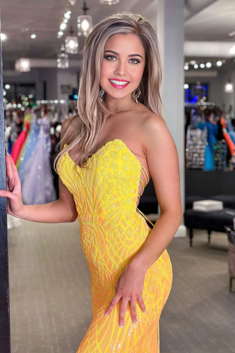 Close-up of yellow sequin fabric on mermaid prom dress.