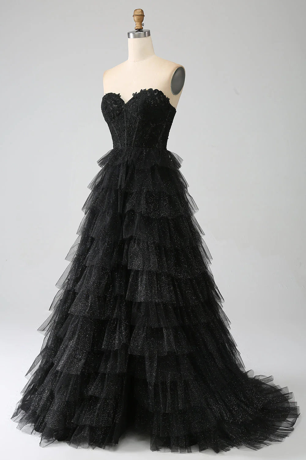 Close-up of the sparkling black fabric and corset bodice of the prom dress.