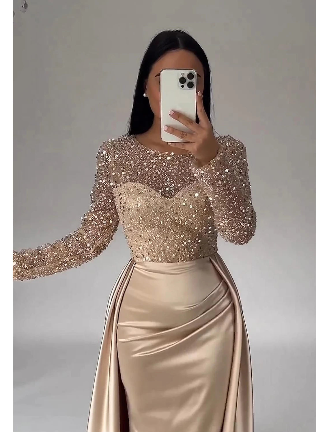 Side view of the floor-length satin evening dress with intricate illusion neckline.