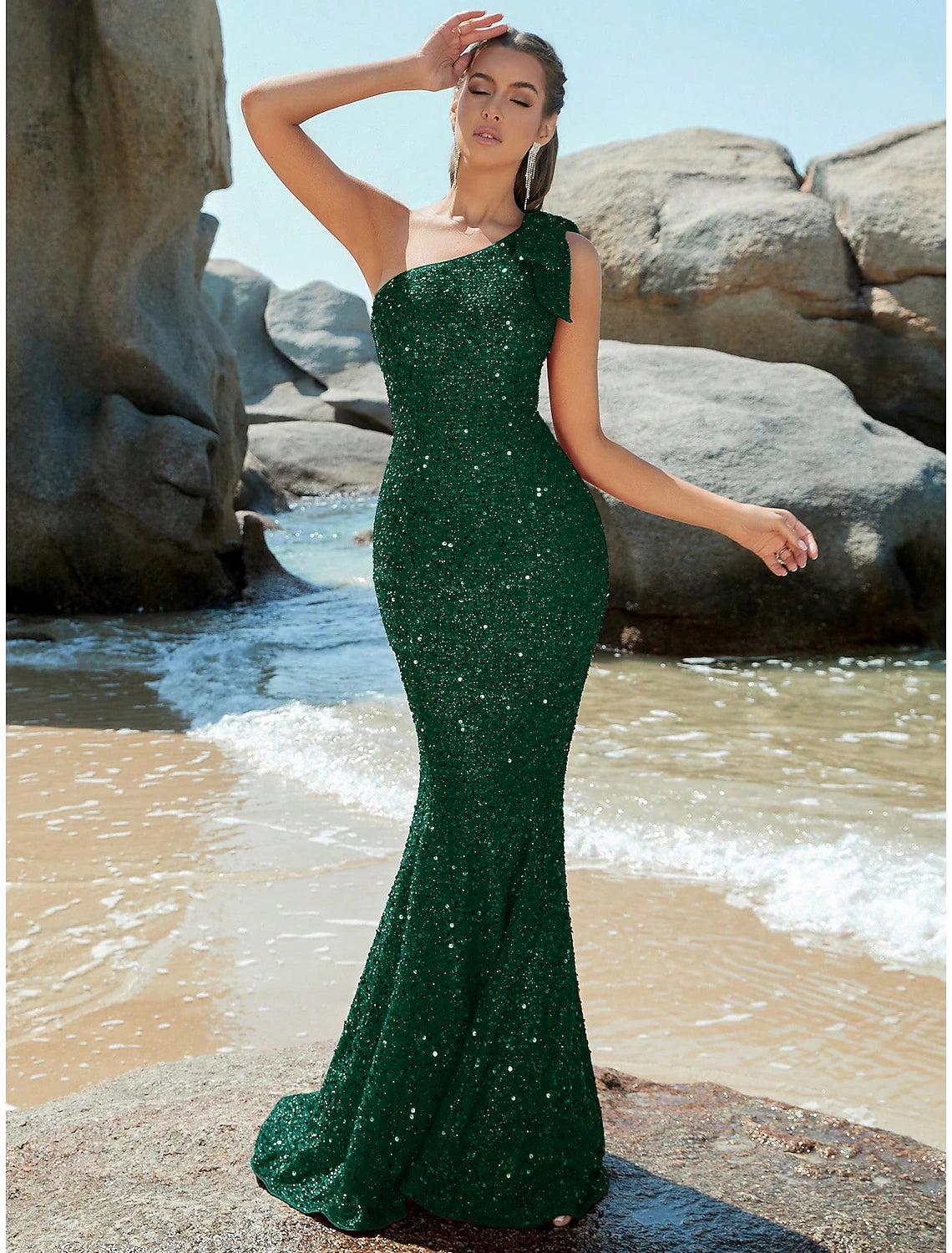 Rose gold sequined mermaid trumpet evening gown with one shoulder and sweep train.