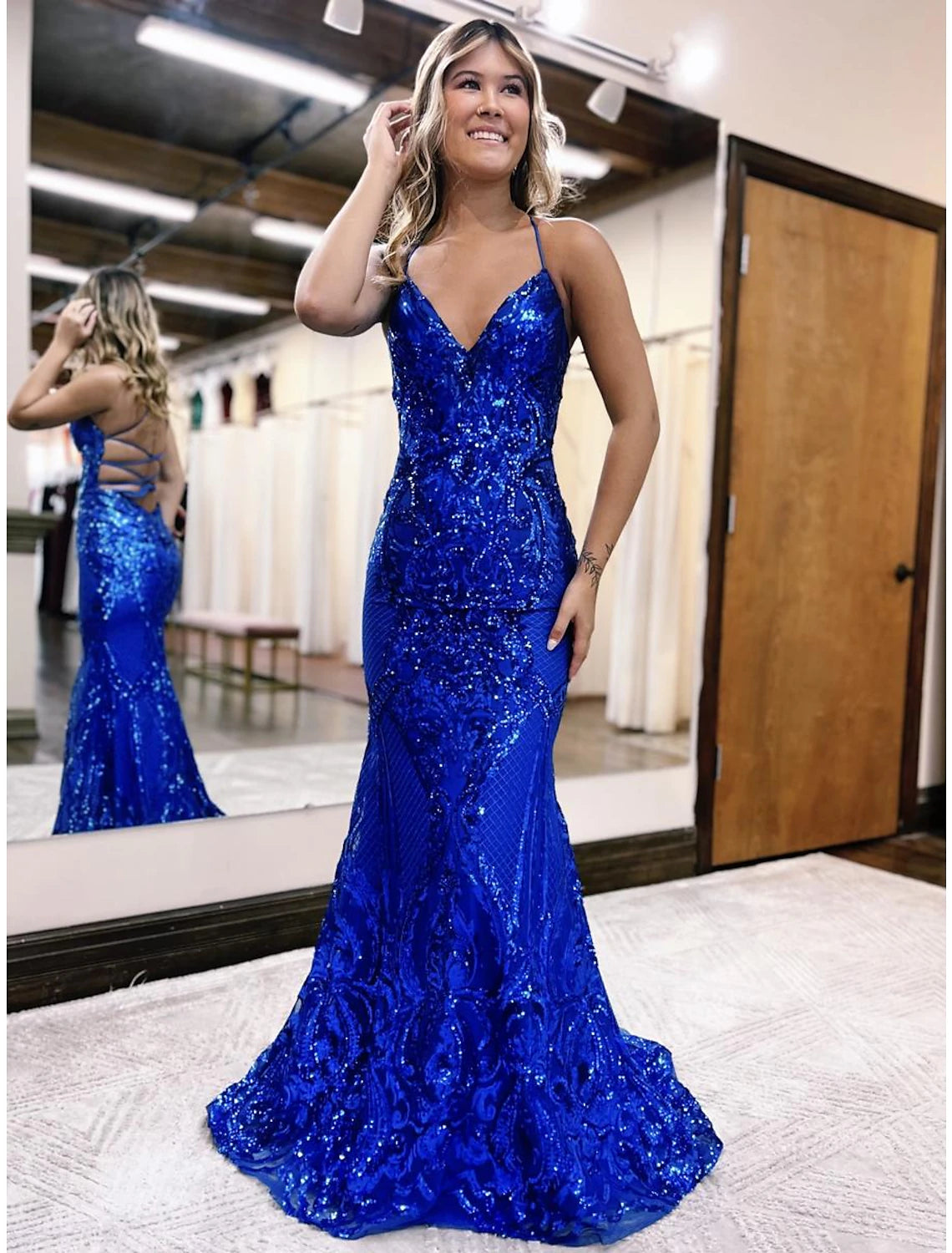 Sparkling mermaid trumpet prom dress with V-neck and sequin details.