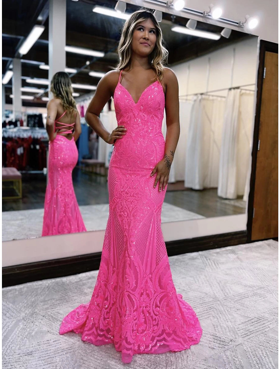 Side view of a sequined mermaid trumpet dress with a sweep train.