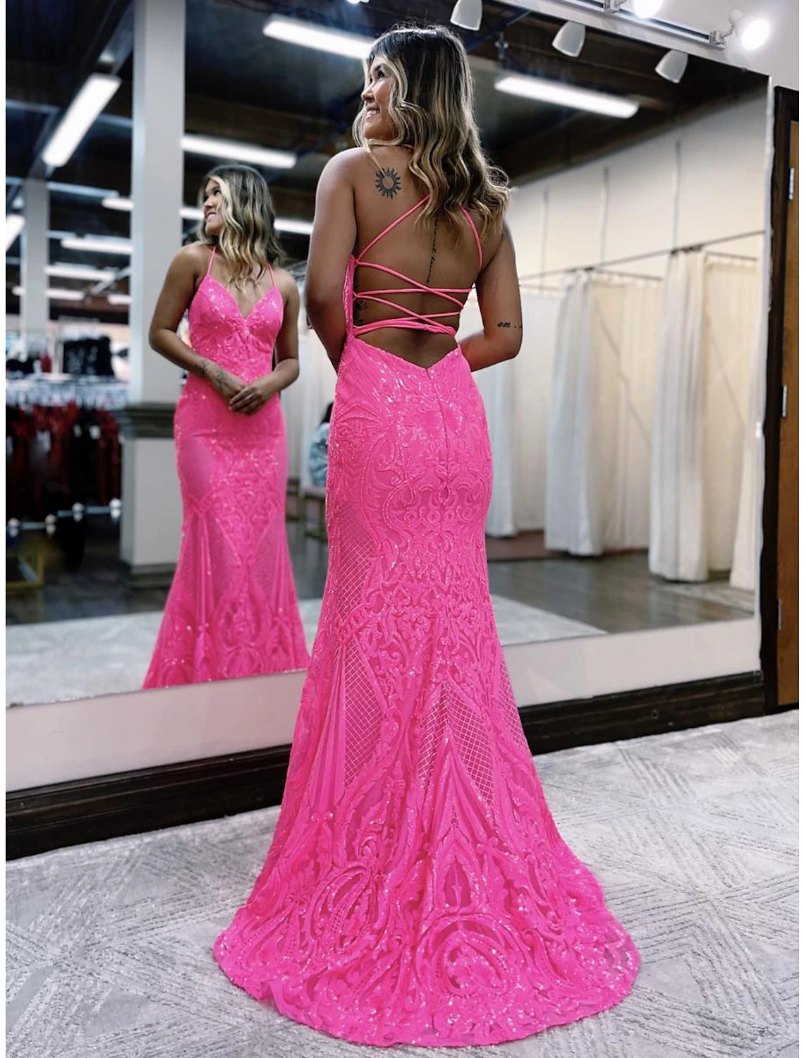 Back view of a backless sequined prom dress with a V-neck.