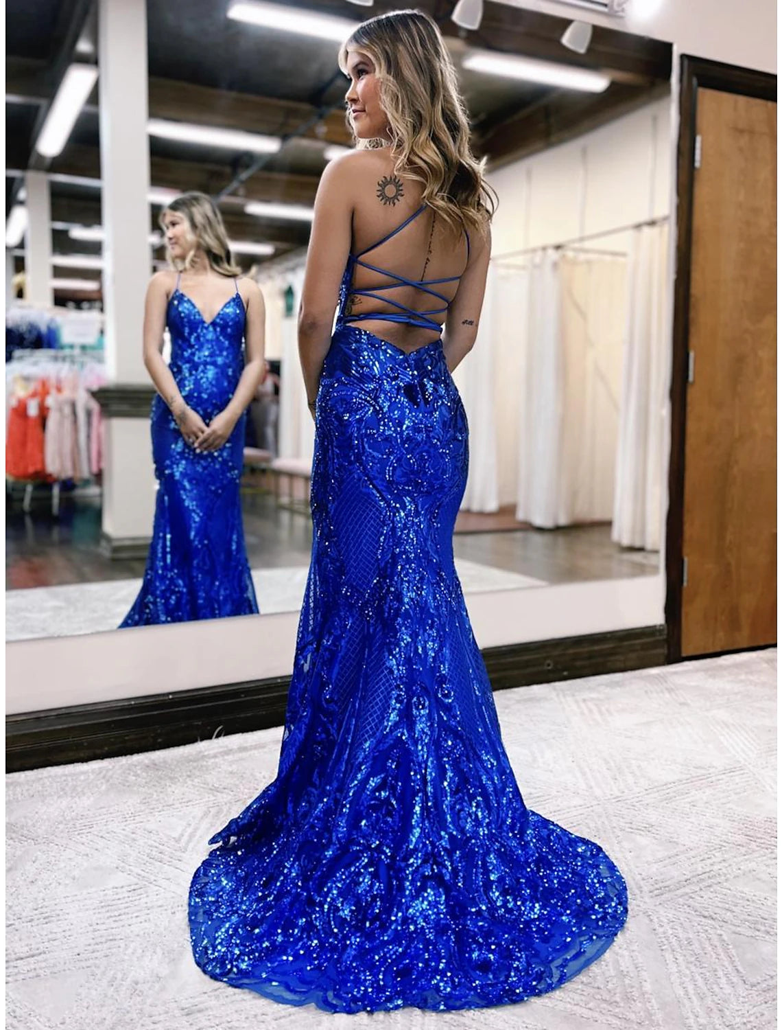Elegant mermaid trumpet gown with glitter and sequin embellishments.