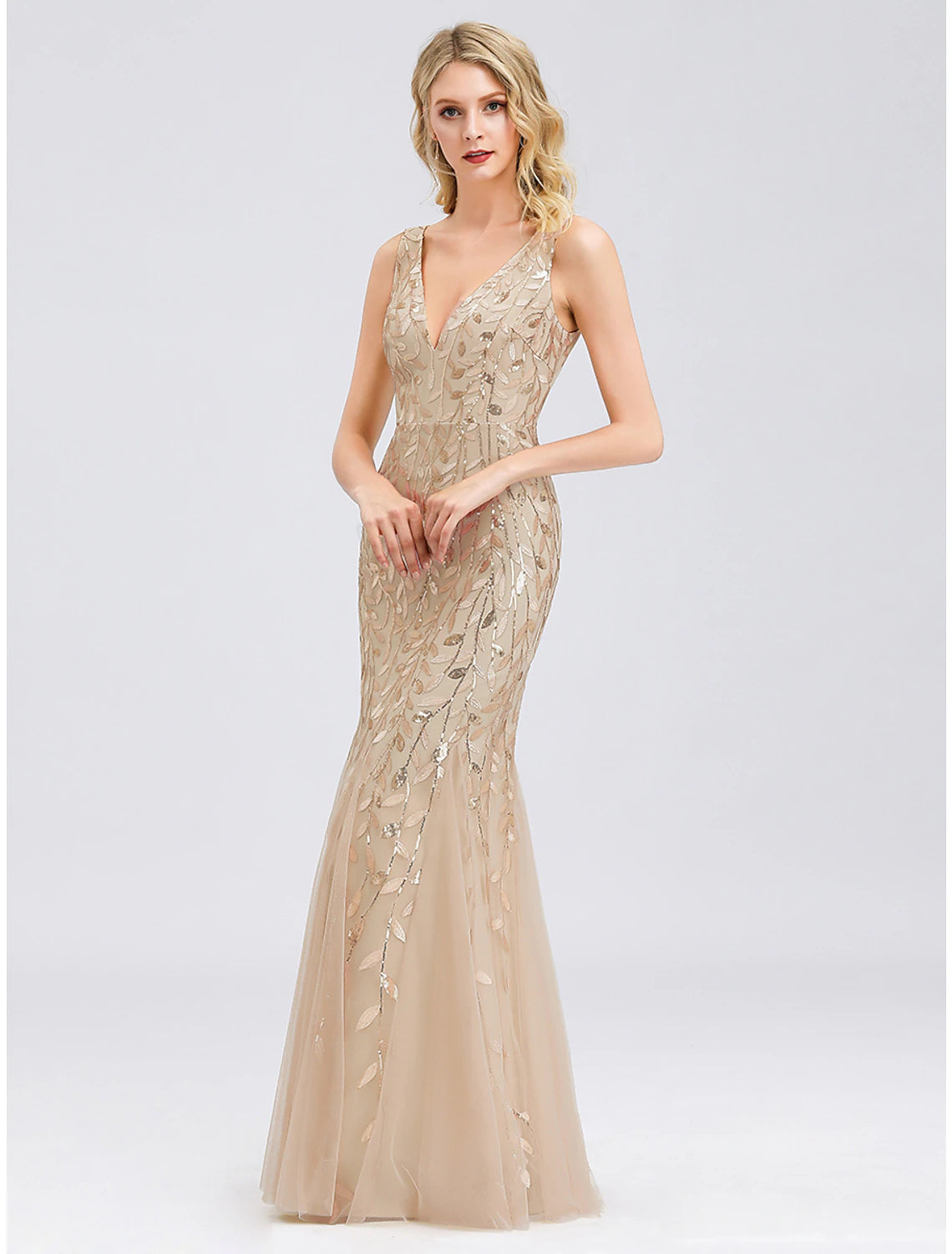 Close-up of sequin appliques on the tulle fabric of the dress.