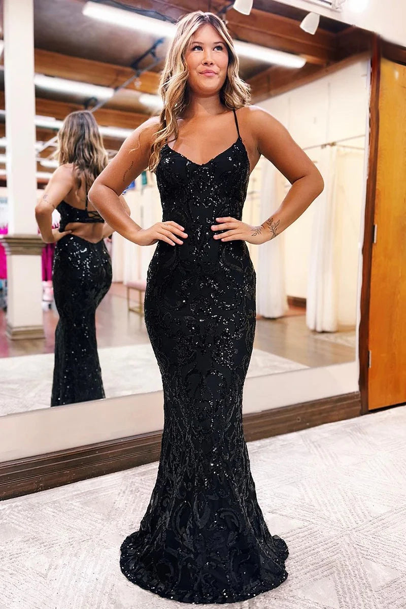 Model wearing a sparkling sequined mermaid prom dress with a V-neck and slit.