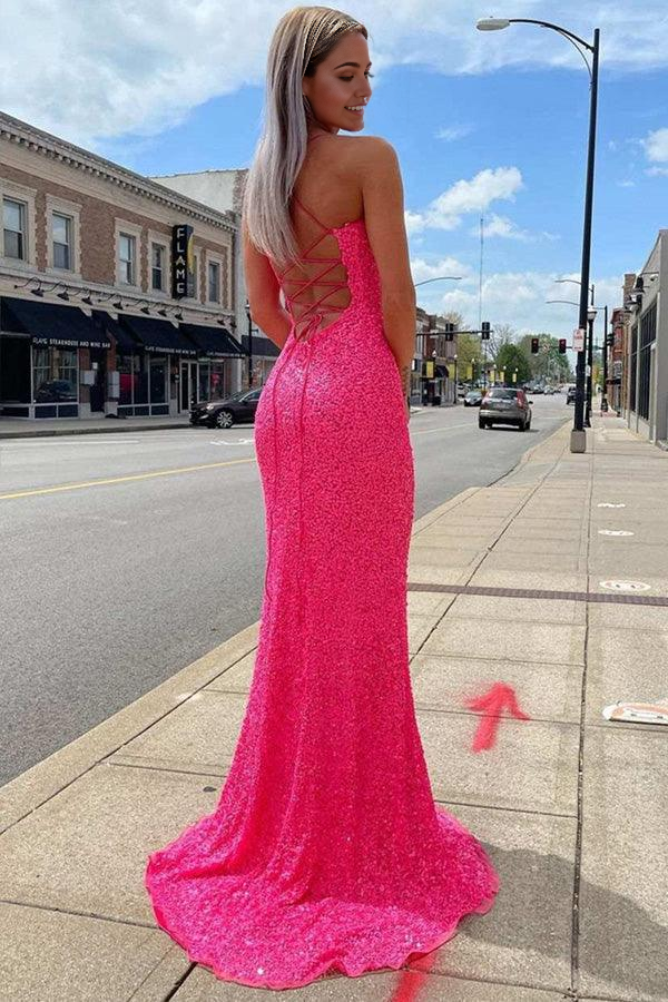 Model posing in a long hot pink glitter evening gown.