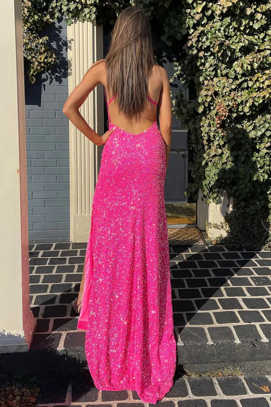 Back view of the hot pink sequin mermaid evening dress, showcasing the elegant train.